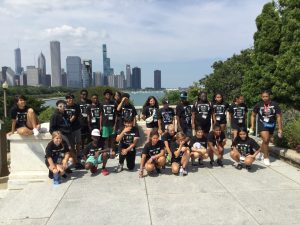Group photo of youth with Chicago in background
